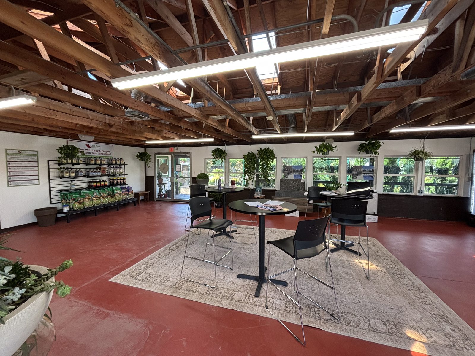 Inside Land Care Garden Center: shelves of garden products and plant care supplies beside the open seating area