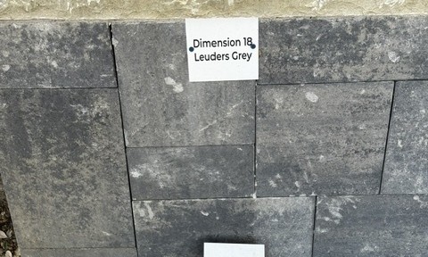 Dimension 18 Leuders Grey cut stone sample on the building stone display wall at Land Care Garden Center in Flower Mound, TX