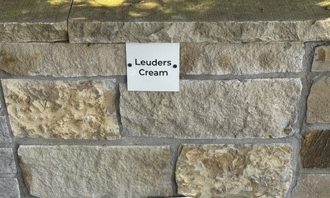 Leuders Cream chopped stone sample on the building stone display wall at Land Care Garden Center in Flower Mound, TX