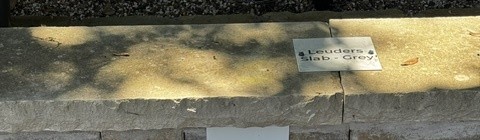 Leuders Slab Grey cap stone sample on the building stone display wall at Land Care Garden Center in Flower Mound, TX